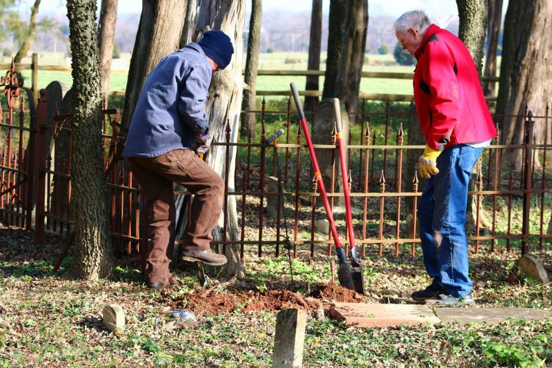 Two men digging in the ground